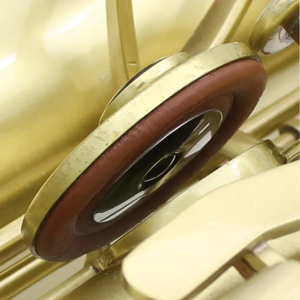 Gold-colored brass saxophone pad with reddish-brown button leather pads for alto soprano sax universal use