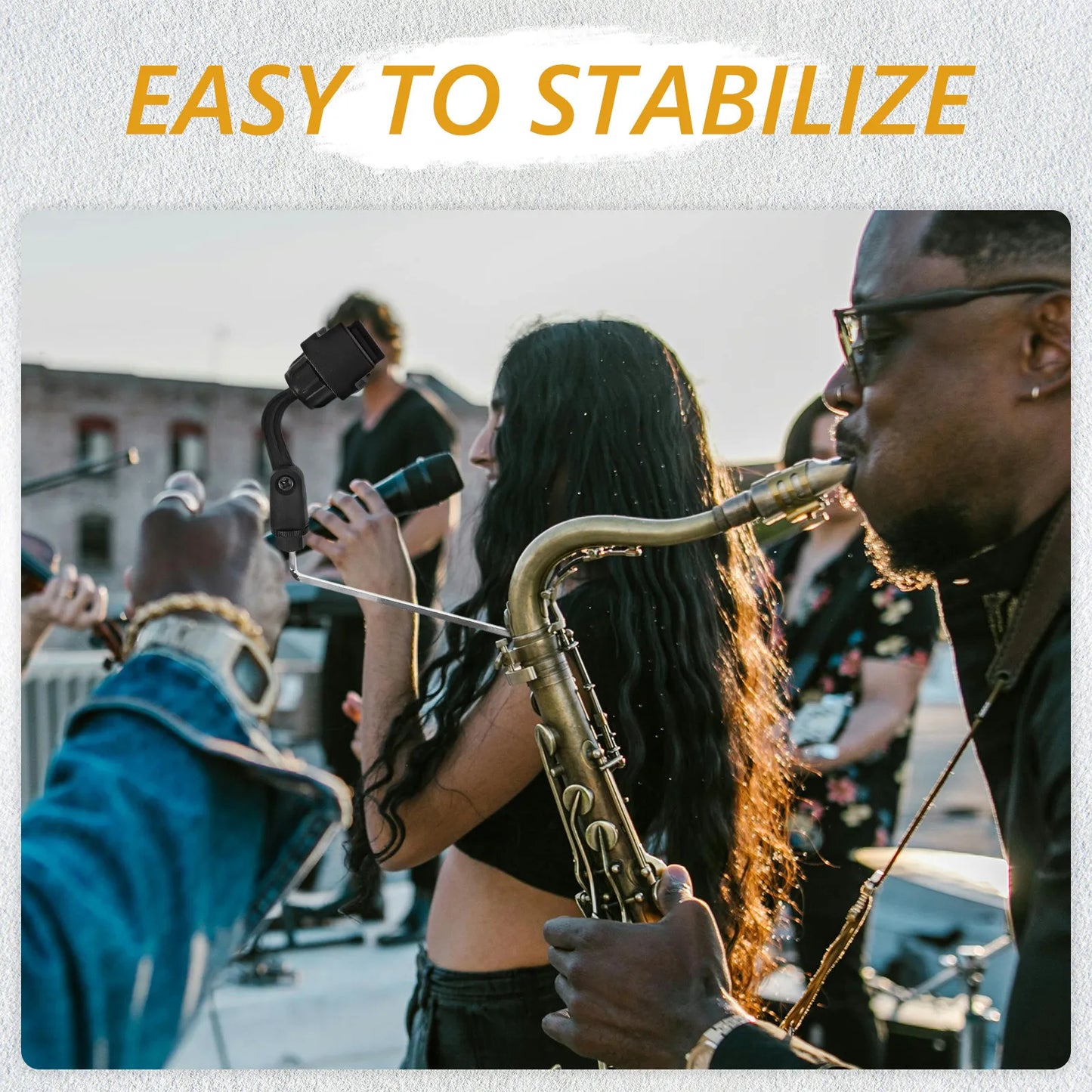 Black handheld gimbal stabilizer with saxophone phone clip and adjustable instrument microphone clip for live performance use