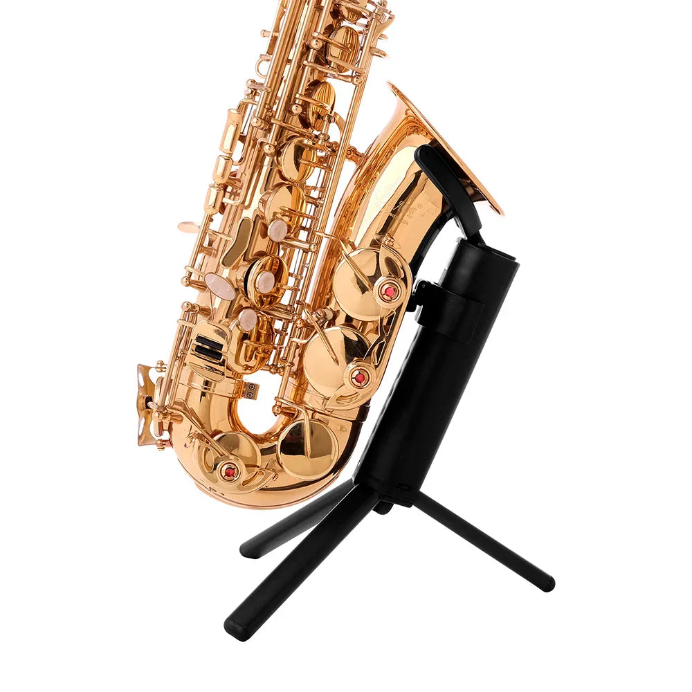 Golden saxophone with polished brass keys and red accents resting on a saxophone stand portable with metal legs tripod