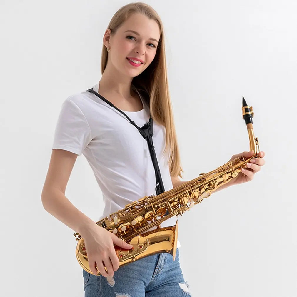 Golden saxophone with black accents and intricate keywork paired with strap saxophone shoulder for neck strap protection