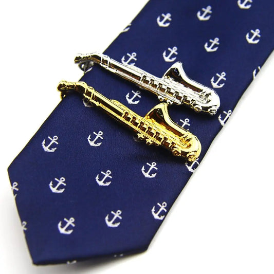 A pair of saxophone tie clips in polished gold and silver tone metal perfect as bar musician gifts or instrument tie bars