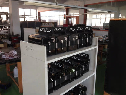 Black seasound oem chromatic bass accordion uc107 with silver keys and decorative trim on white shelving unit for children