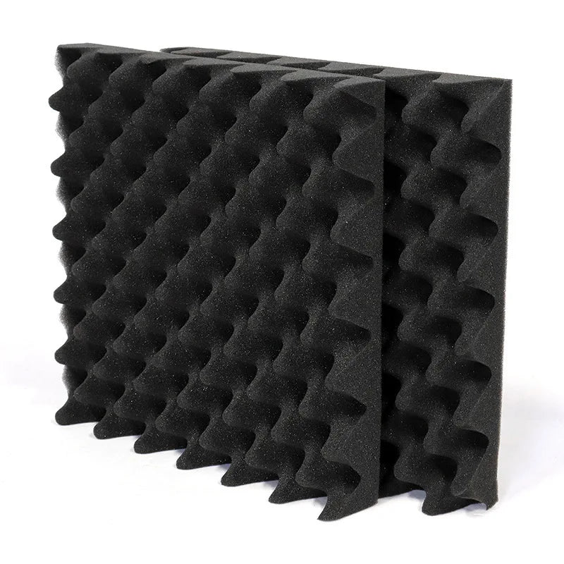 Black self-adhesive soundproof foam panels with eggcrate acoustic wall texture for home studios and noise reduction