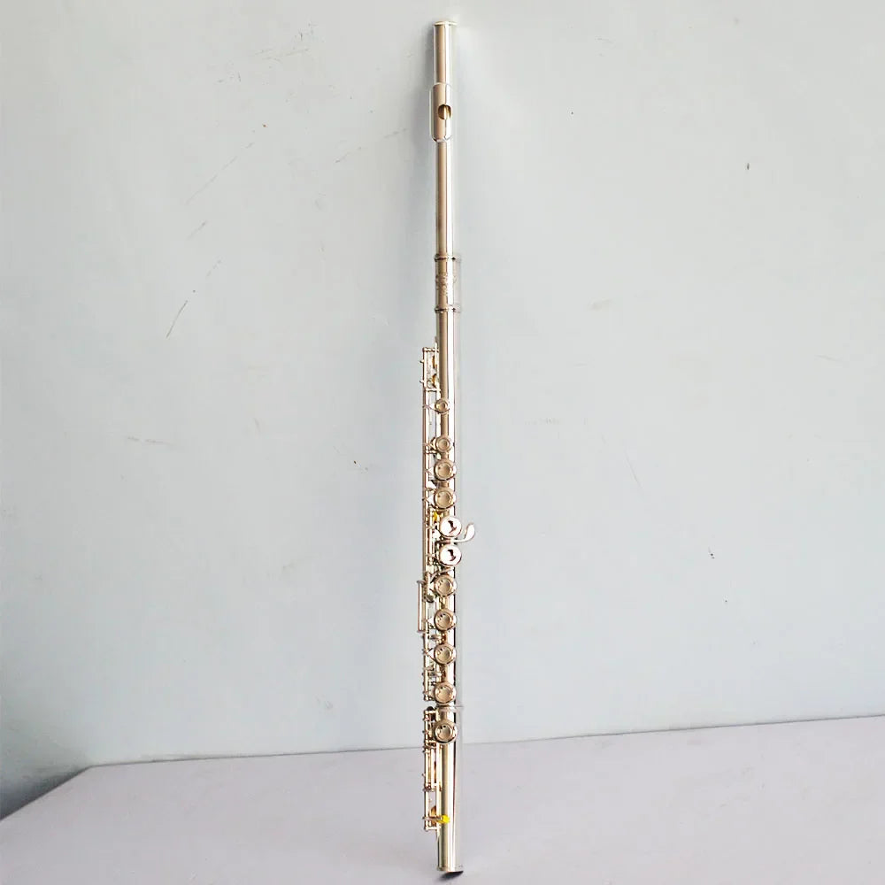 A high quality silver plated flute with 16 17 hole closed keywork featuring polished metallic finish for playing instruments