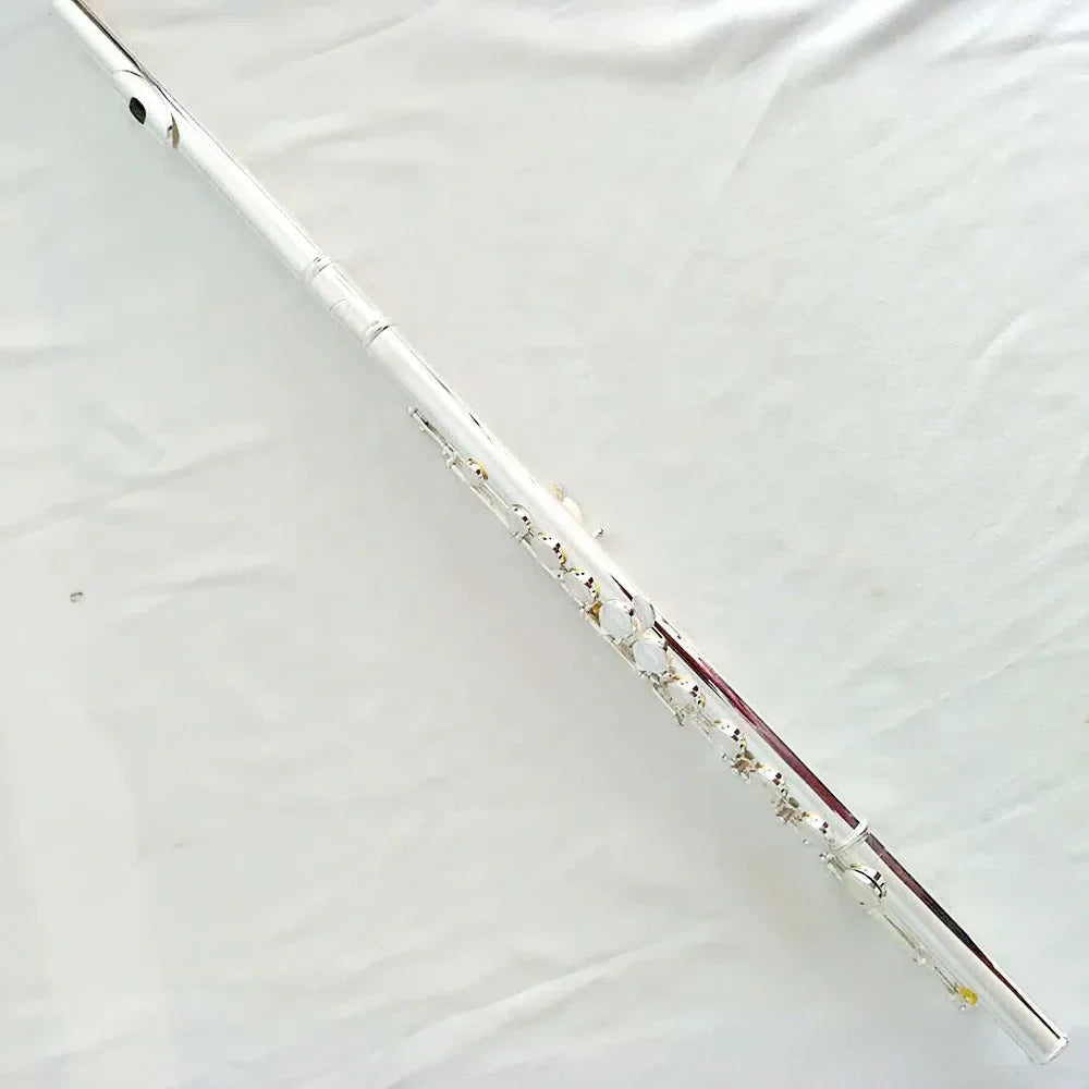 A high quality silver plated flute with 16 hole 17 hole closed keywork and polished metallic finish for playing instruments