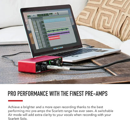 Red scarlett solo audio interface with black knobs and white cables paired with sennheiser mk4 large karaoke condenser microphone for live broadcast professional use