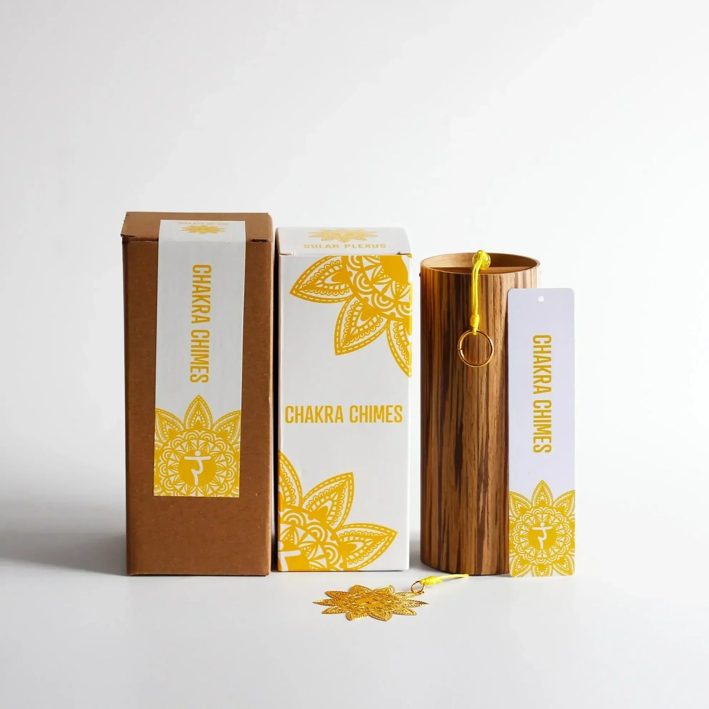 Wooden cylindrical seventh chord wind chime with yellow loop and gold charm for meditation yoga japanese use