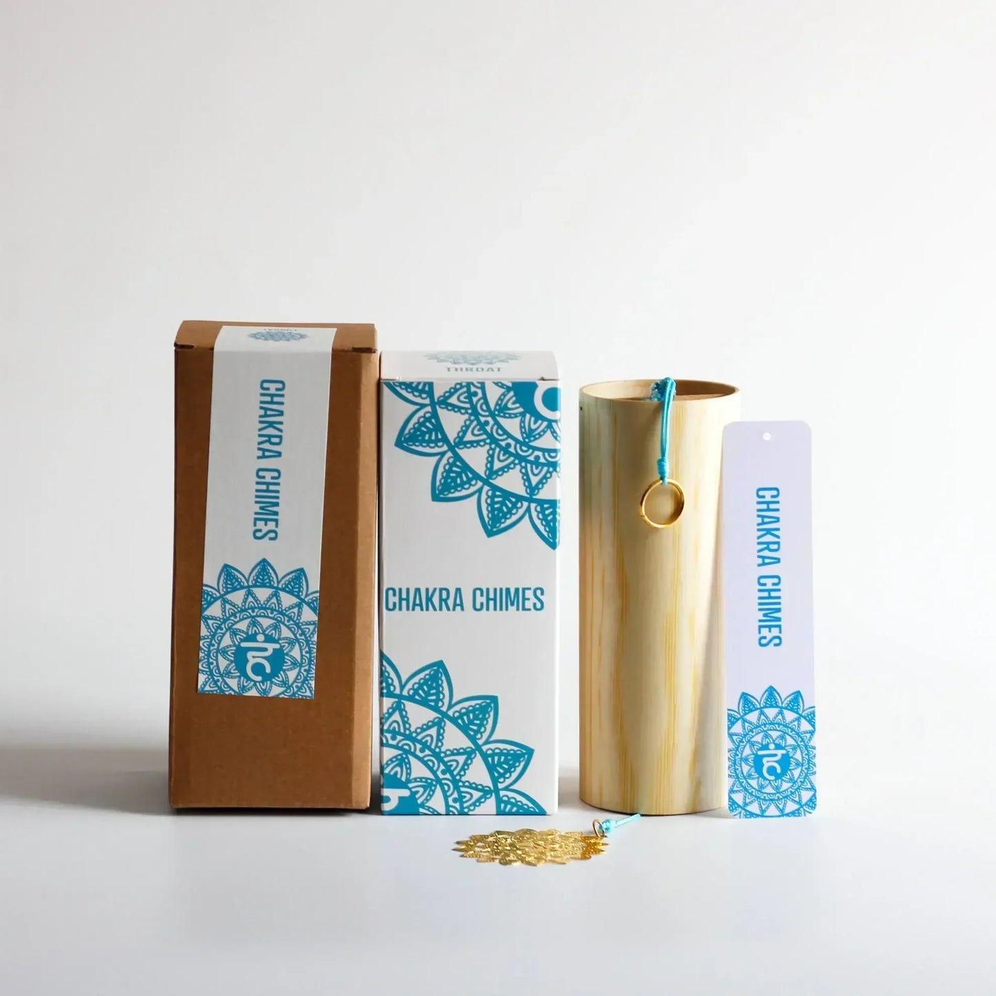 A golden bamboo seventh chord wind chime with a teal cord and gold ring for meditation yoga japanese use