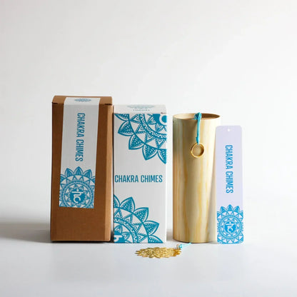 A golden bamboo seventh chord wind chime with a teal cord and gold ring for meditation yoga japanese use