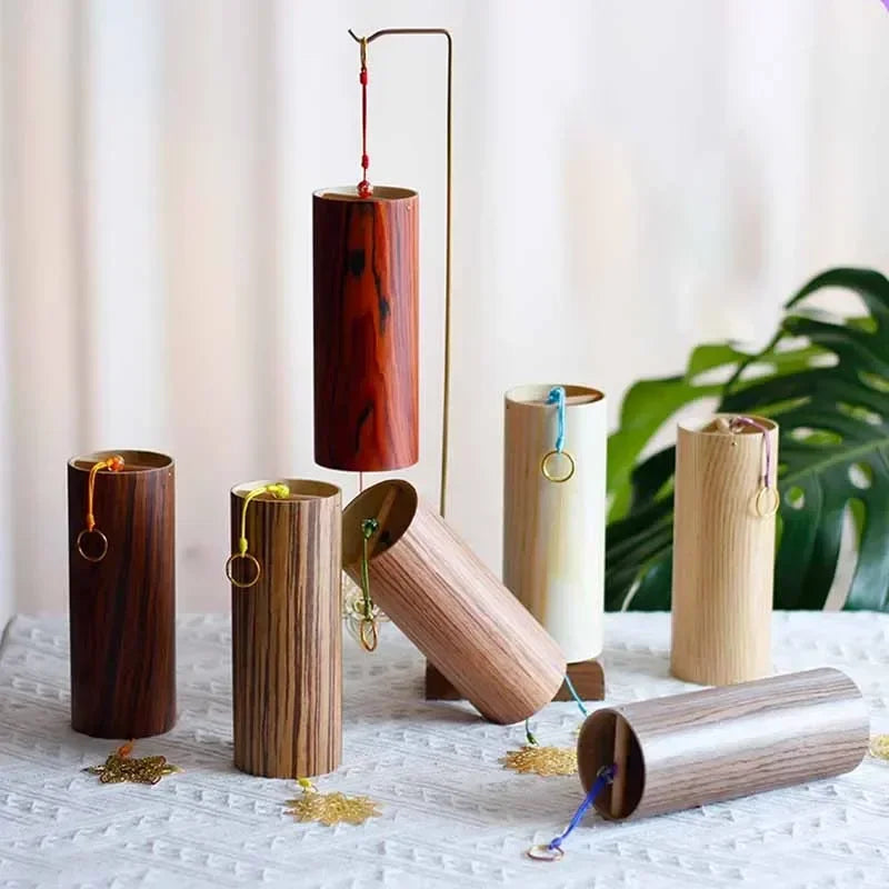 A set of cylindrical wooden seventh chord wind chimes with colorful strings for meditation yoga japanese sound therapy