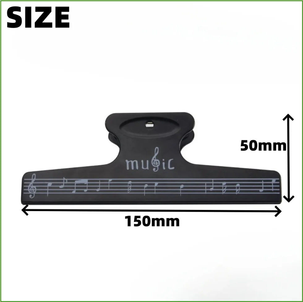 Black plastic sheet music clip with musical notes and music engraving used as score fixed clips for instruments