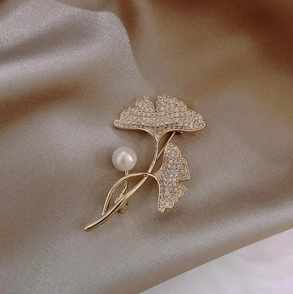 Gold-toned ginkgo leaf brooch with crystal detailing and central pearl for women music accessory and clothing decoration