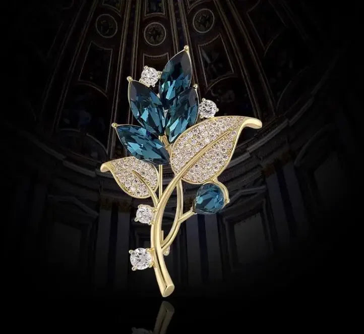 Gold-toned floral brooch with deep blue marquise crystals and clear diamonds for music accessory and clothing decoration