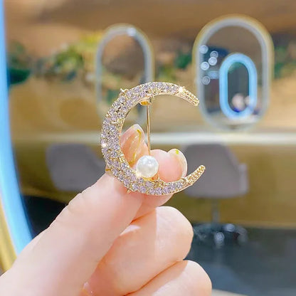 Gold-toned crescent moon brooch with sparkling rhinestones and a pearl, exquisite crystal violin accessory for women