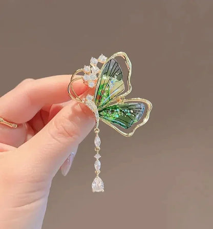 Shinny crystal violin pearl brooch for women with gold-toned butterfly, translucent green wings, and sparkling clear crystals