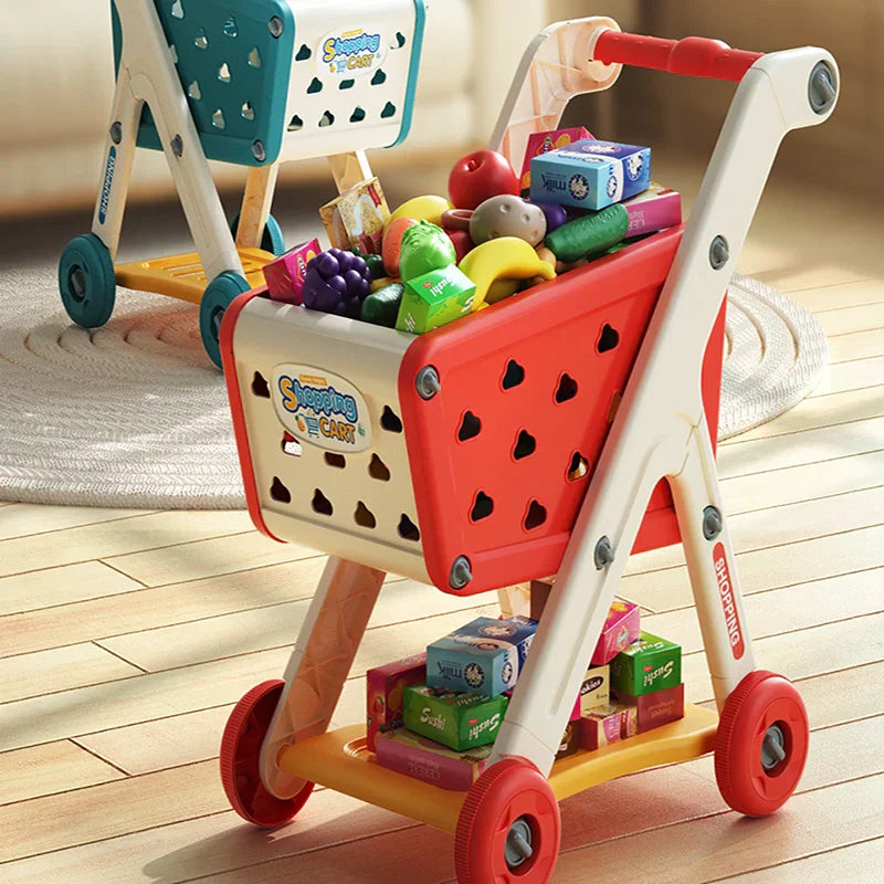 Red and white plastic shopping cart toy with heart cutouts filled with colorful groceries for music kitchen supermarket play