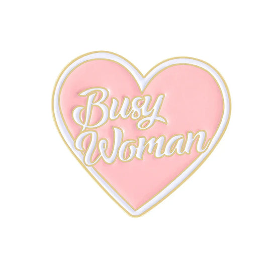 Pink heart-shaped enamel pin with busy woman in white cursive and gold outline perfect as sweet enamel pins accessory