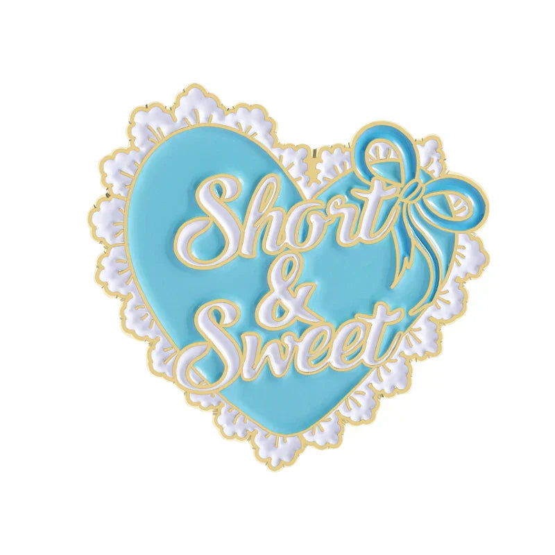 A light blue heart shaped enamel pin with white lace border and gold trim featuring short and sweet text for smile brooches clothes