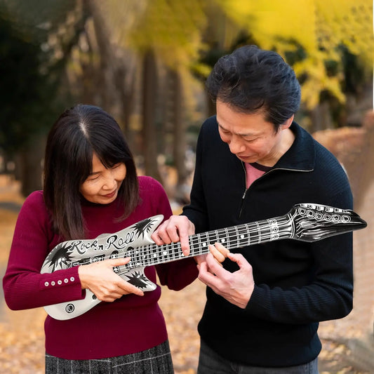 Silver inflatable guitar prop with black palm tree and rock n roll lettering for music party decorations from beat music store