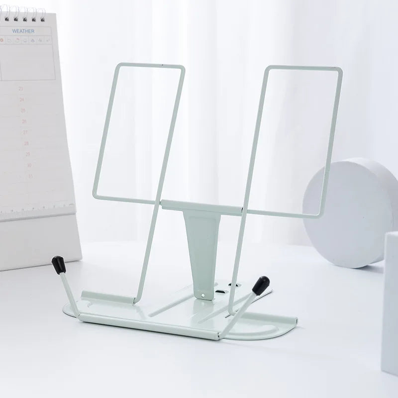 White metal reading stand with adjustable arms and black rubber feet for stable portable music score use