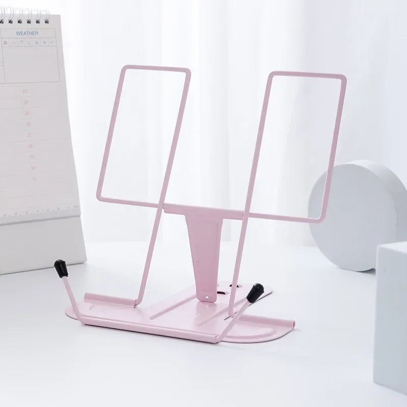 Pink metal reading stand with adjustable arms and black rubber feet for a stable foldable music score stand