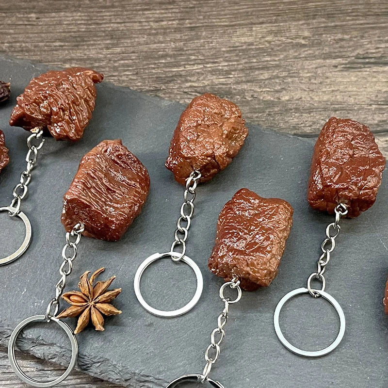 Brown textured simulation beef keychain with silver metal chain made of imitation food pvc beef grain design