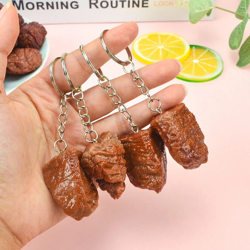 Four brown simulation beef block keychains made of imitation food pvc with silver metal chains and rings