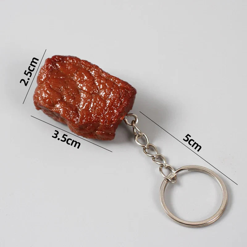 A glossy reddish-brown simulation beef block keychain with detailed beef grain texture made of imitation food pvc