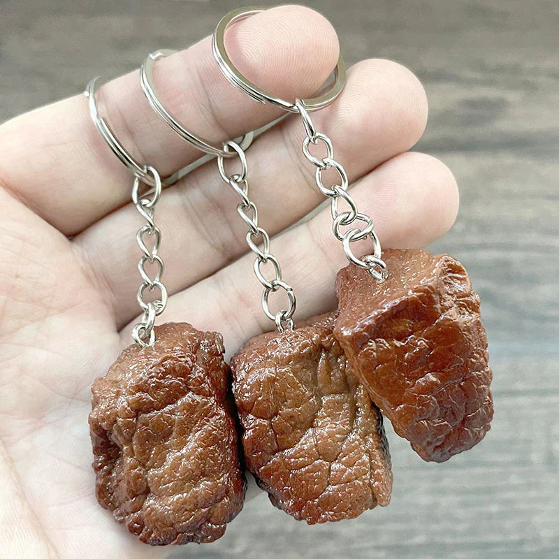 Three brown simulation beef grain keychains made of imitation food pvc with silver rings and chains for fashion jewelry