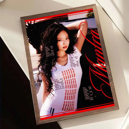 A framed retro poster of singer jennie from ruby album featuring a woman in white t-shirt on black background
