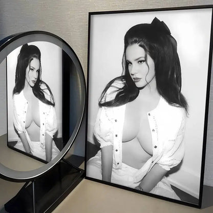 Black-framed modern graphic singer l-lana del rey poster with black-and-white portrait and white blouse for wall decor