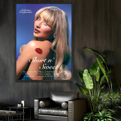 A modern graphic framed poster of singer Sabrina Carpenter with blonde hair and red lipstick mark on blue background
