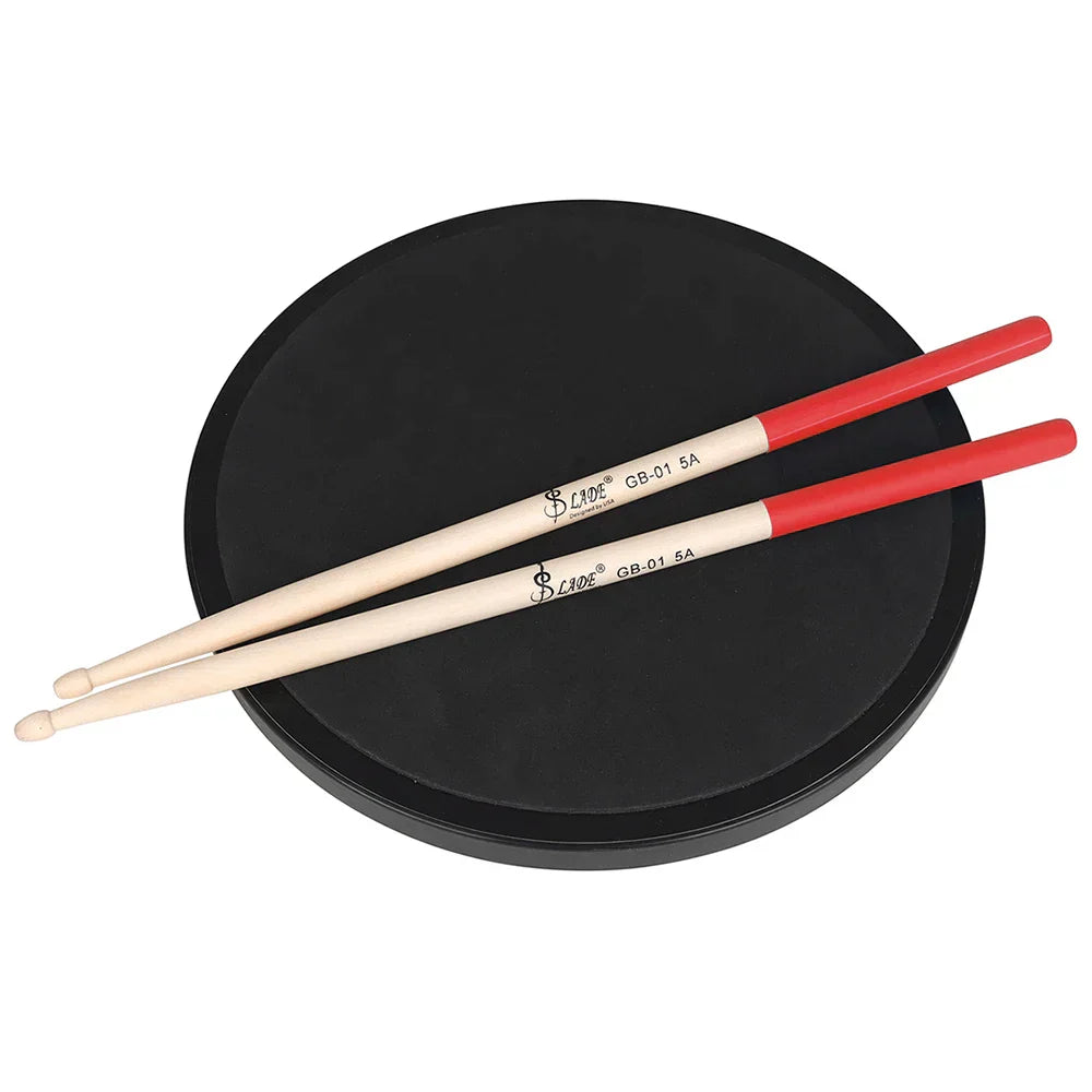 Red-tipped pair 5a maple professional wooden percussion drumsticks with black branding rest on a black practice pad