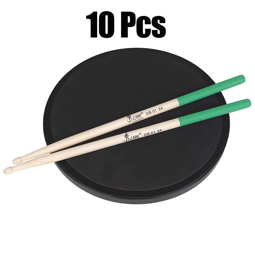 A pair of beige 5a maple drumsticks professional with green handles resting on a black practice pad percussion accessories
