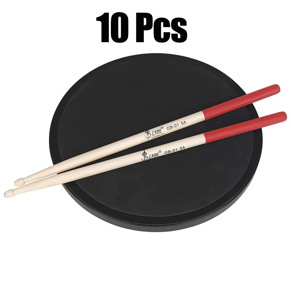Red and cream-colored maple drumsticks professional with black branding on black circular practice pad percussion accessories
