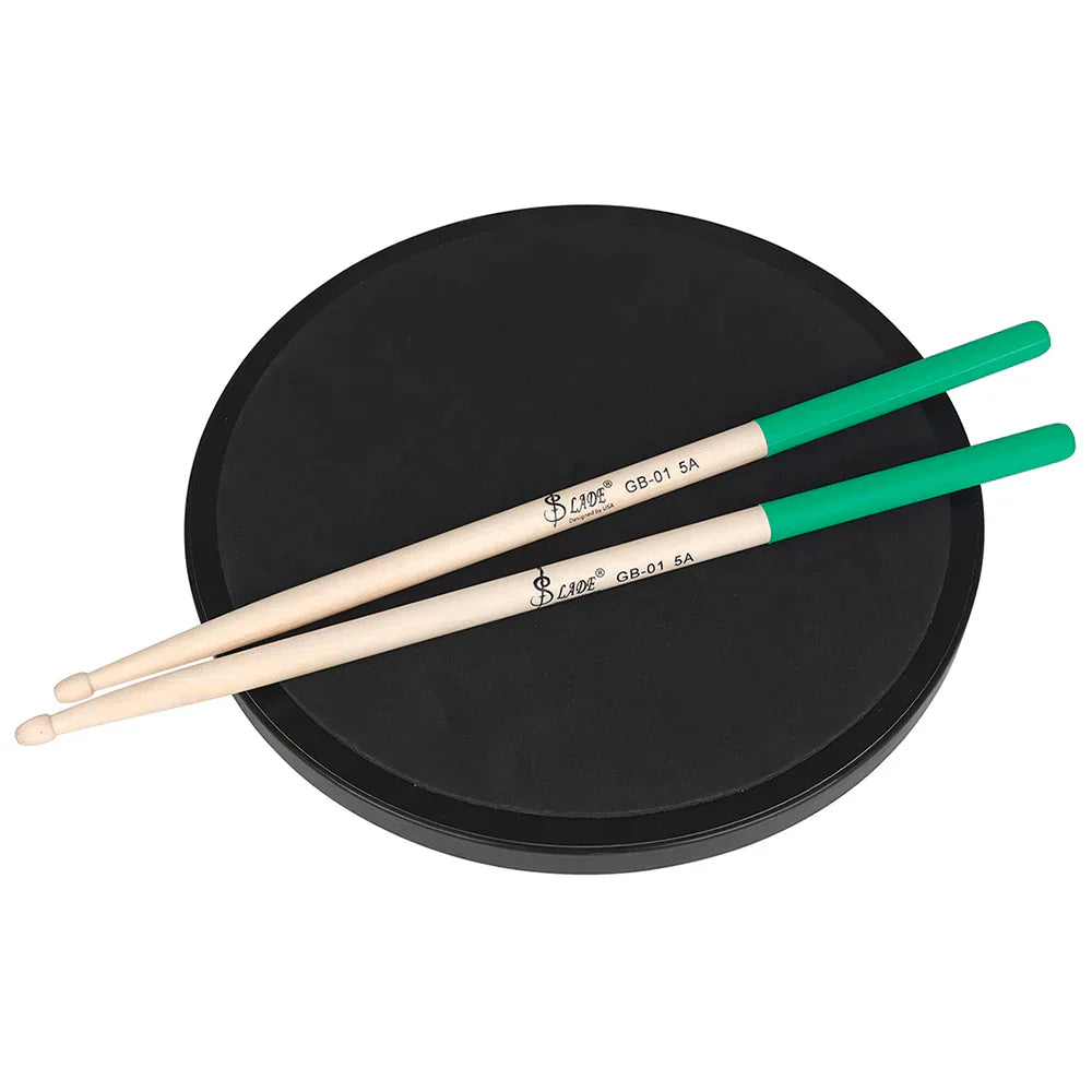 A pair of light maple drumsticks professional with bright green tips resting on a black practice pad for percussion accessories