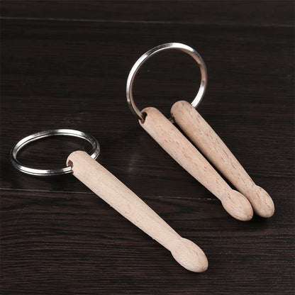 Small light-colored wooden drum sticks keychain with silver metal ring for wood drumsticks percussion use
