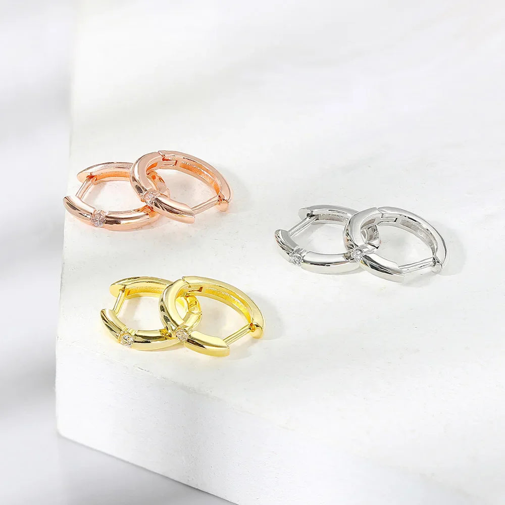 Three pairs of small hoop earrings for women in rose gold yellow gold and silver with diamond accents for hip hop jewelry