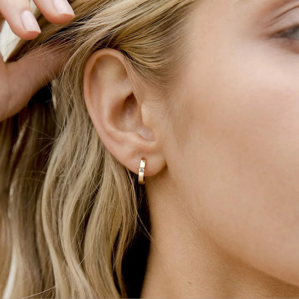 Gold-toned small hoop earring with a rectangular clear zircon stone for men and women hip hop jewelry piercing