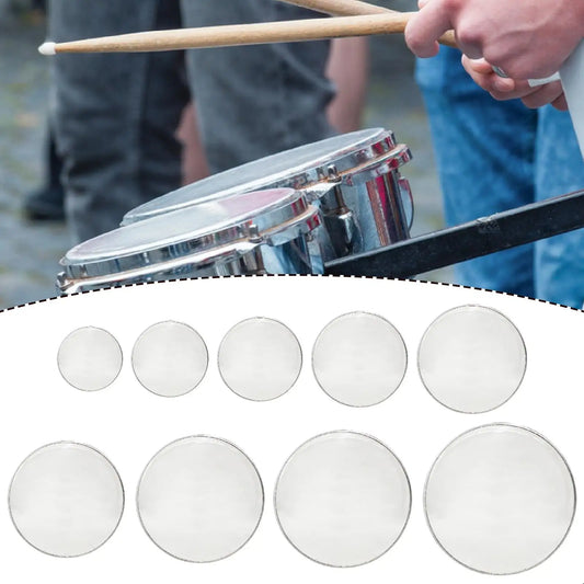 Set of clear circular snare drum heads with metallic rims as transparent replacement for sound control in drums