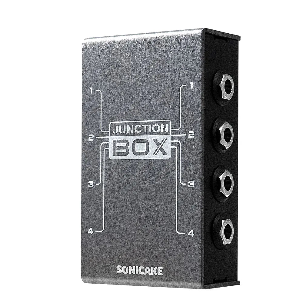 Silver metallic sonicake junction box with four black hex input jacks and signal routing for guitar bass pedal instruments
