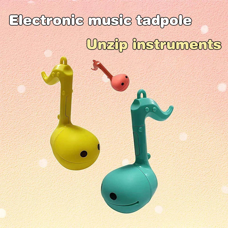 Yellow and teal plastic musical notes otamatone mini electronic tadpoles with cute smiling faces for creative sound play