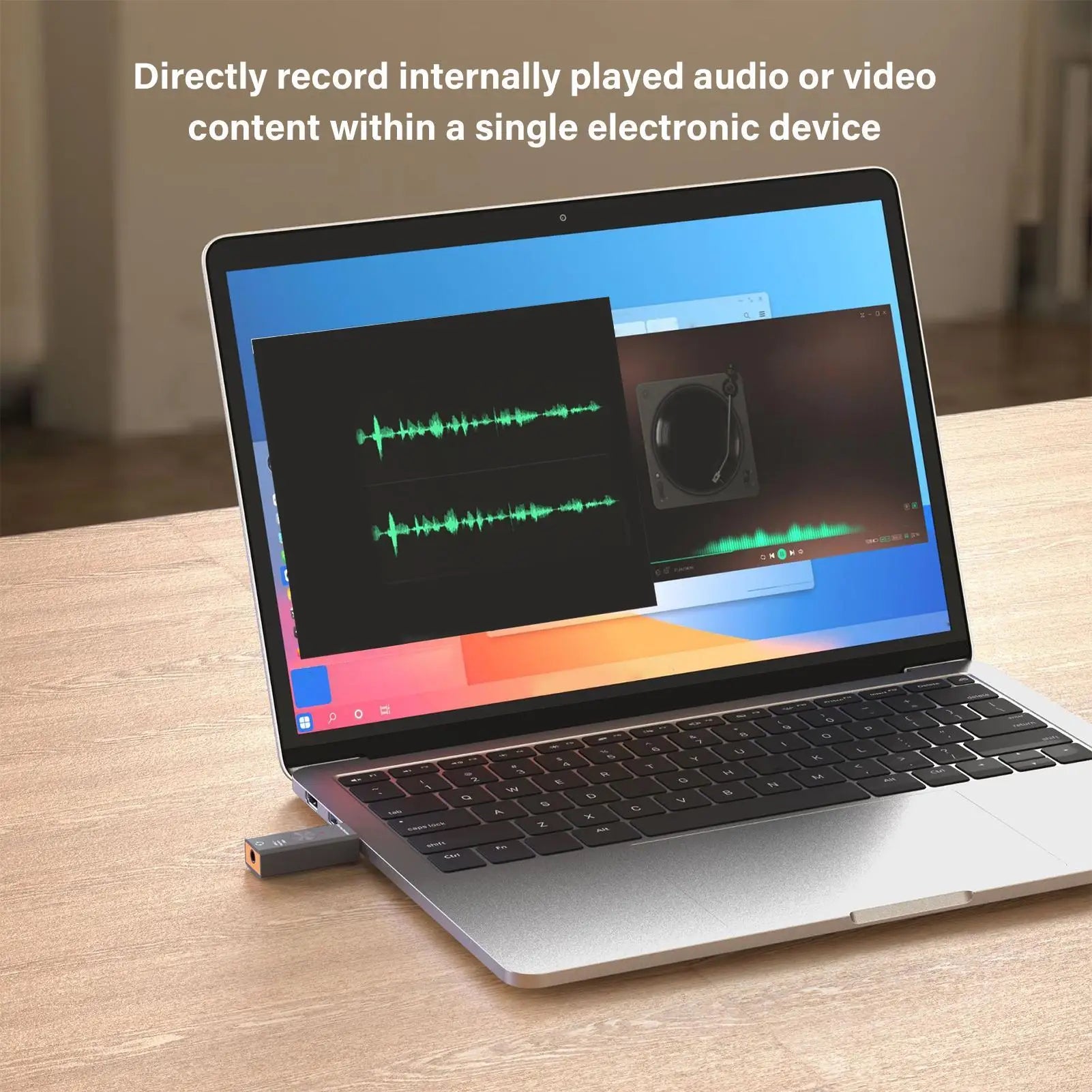 Silver laptop with black keyboard and usb noise reduction adapter plugged in for studio podcast game live streaming use