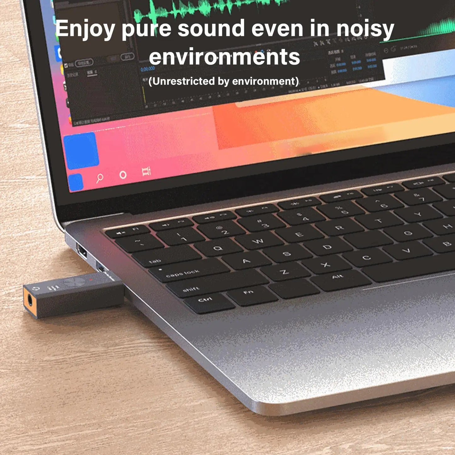 Black and orange usb audio adapter plugged into laptop port noise reduction converter for studio podcast game live use