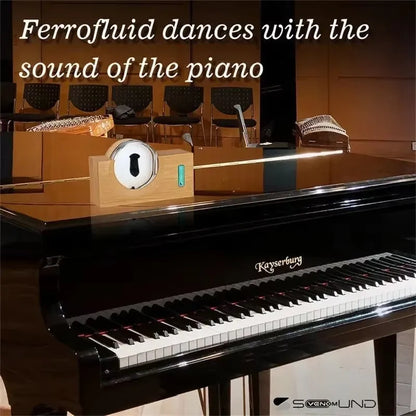 A sleek black kayserburg grand piano with polished finish and white ebony keys featuring magnetic fluid pickup