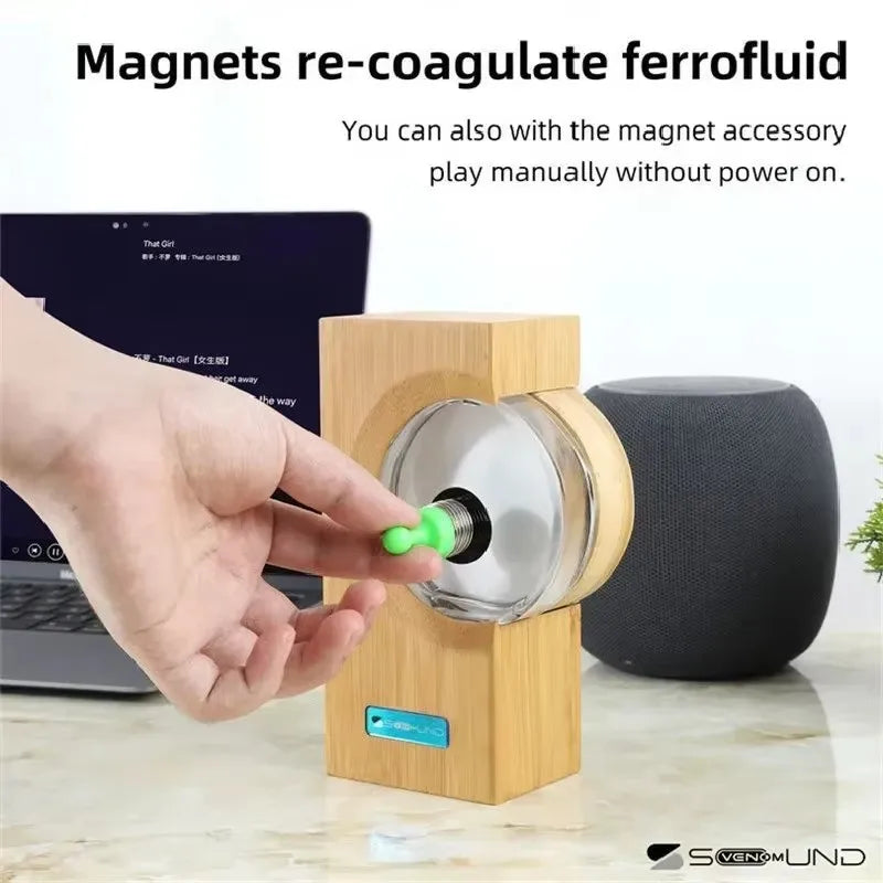 A sleek wooden sound equipment motion sensor with transparent glass containing magnetic fluid for music sound touch interaction