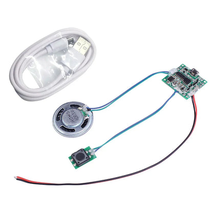 Silver circular mini speaker with metallic grille connected to circuit board and black button for sound recorder module diy music box