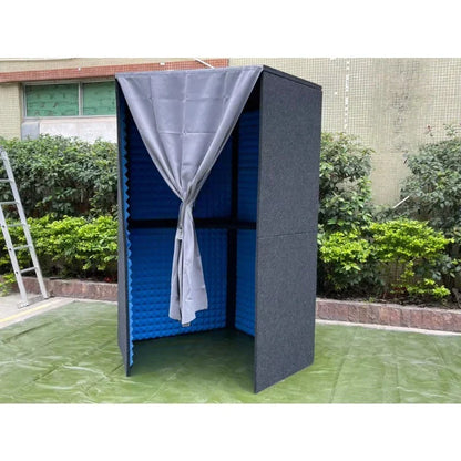 A gray fabric curtain tied in a bow hangs on a black and blue portable home studio professional sound table booth
