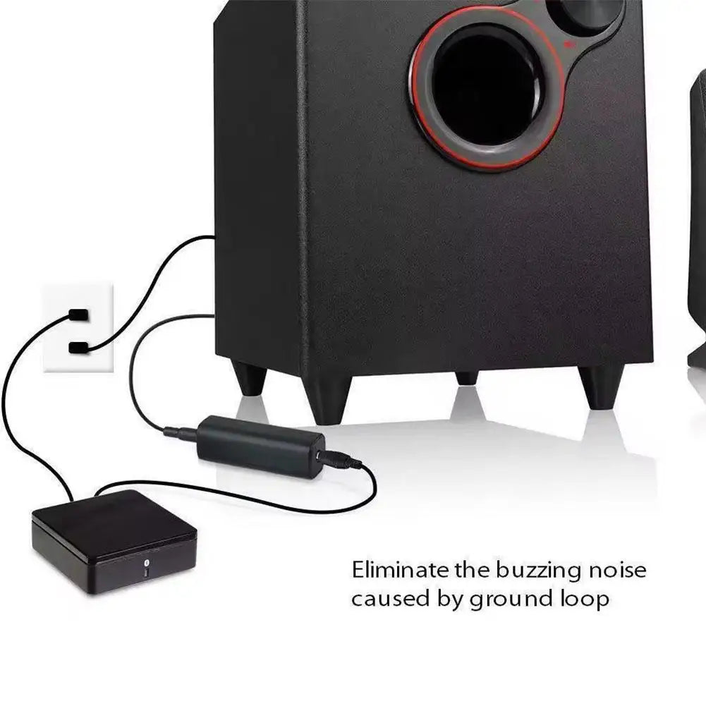 Black subwoofer with red-accented driver connected to car stereo audio system with noise filter ground loop noise isolator