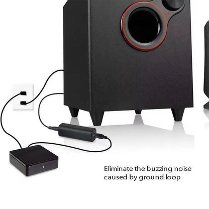 Black subwoofer with red-accented driver connected to car stereo audio system with noise filter ground loop noise isolator